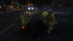 Firefighters inspect the burnt motorcycle