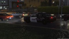 An officer waits patiently at a stop light while on patrol.