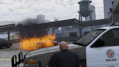 A vehicle on a parking garage is on fire!