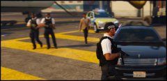 Officers diligent in their security role as a visiting dignarys aide goes about his business