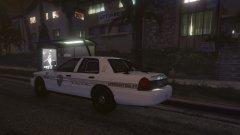 A NCPD patrol car awaits its officer as the officer deals with a domestic dispute.