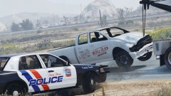 A heavily damaged Bison being towed away from the crash scene