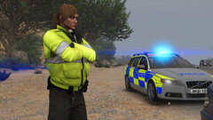 Traffic Officer watches while her colleague deals with the driver