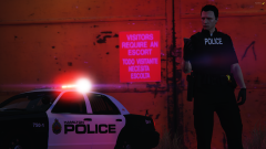 A Hamilton Police Officer with a Marked Crown Victoria in the background