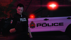 A Hamilton Police Officer with a Marked Ford Explorer in the background