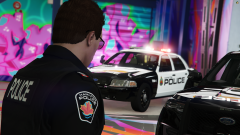 A Hamilton Police Officer with a Marked Crown Victoria in the background