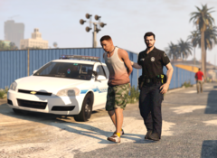 A West Los Santos Police Officer escorts a drunk male to a patrol vehicle.